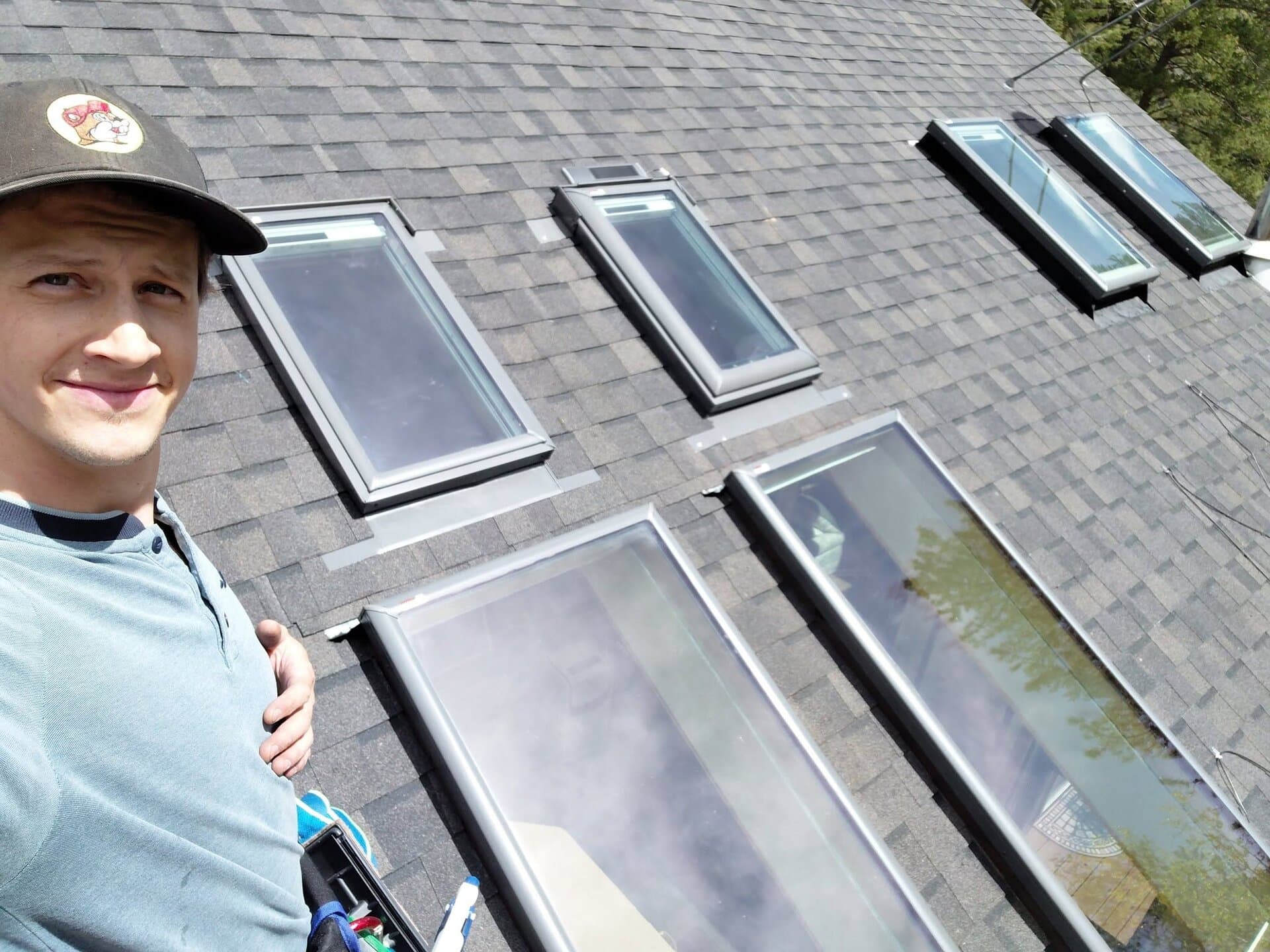 Josh cleaning a rooftop of skylights